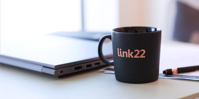 laptop and mug with link22 logo
